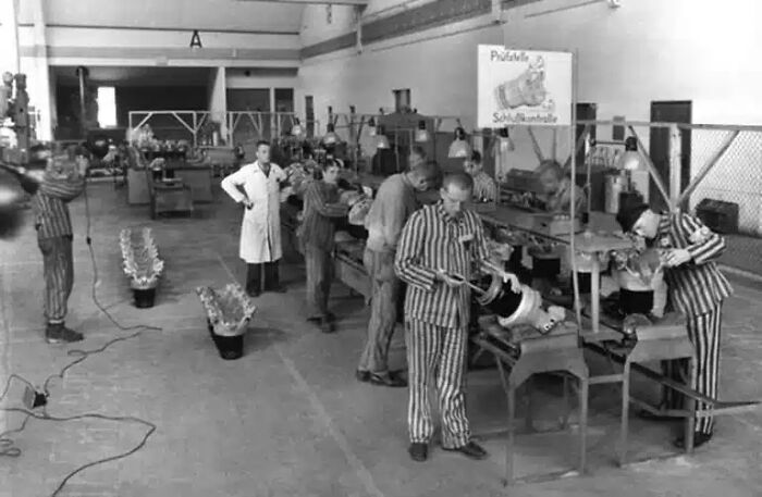 An eerie historical photo shows prisoners in striped uniforms working in a factory, one of many impossible to explain historical photos.