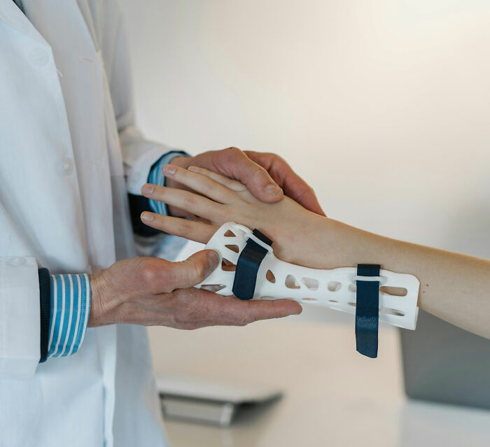 A doctor examines a boy's arm with a modern, breathable plaster cast, revealing a surprise.