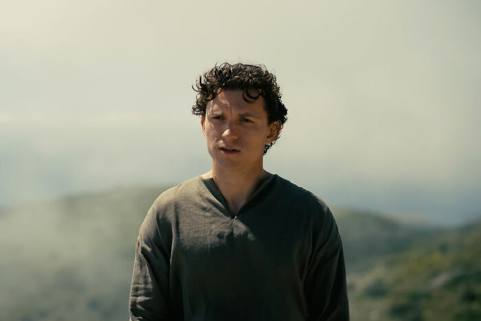 Young man with curly hair in natural landscape scene from The Odyssey Young man with curly hair in natural landscape scene from The Odyssey