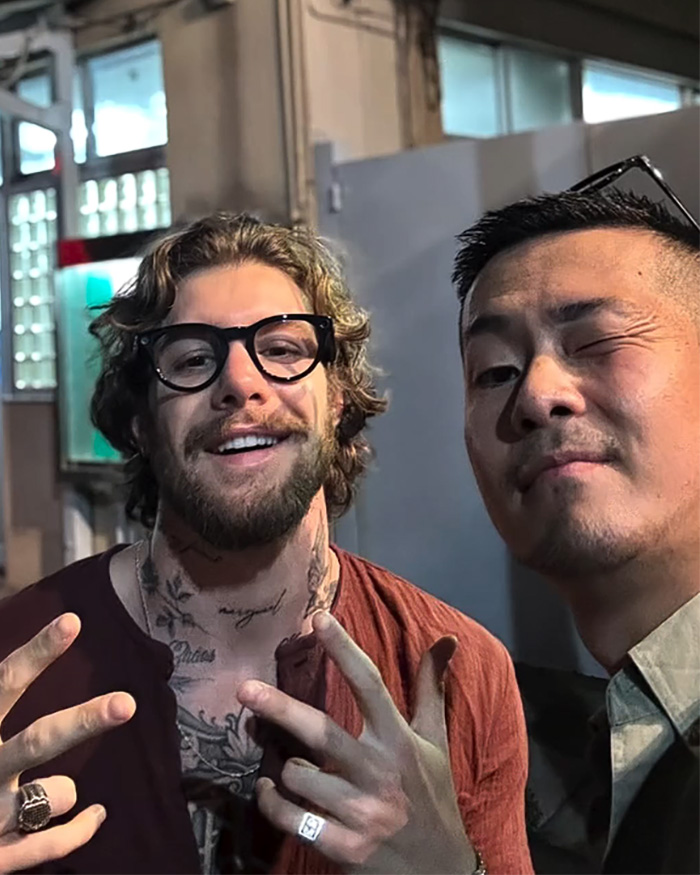A tourist posing with a local, showing the human element of exploring the dark side of Japan.