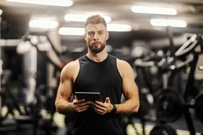 A gym trainer, summoned to deal with a kid who stole a hair towel and his accusing mommy dearest, stands in a gym. A gym trainer, summoned to deal with a kid who stole a hair towel and his accusing mommy dearest, stands in a gym.