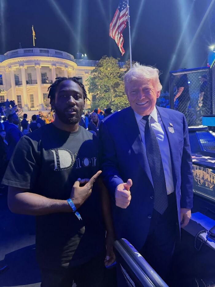Two men posing at UFC 250 fight on the White House lawn with American flag and White House background