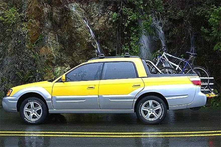 A yellow and grey ugly car with a bicycle rack, parked by a waterfall, a legendary ugly car.