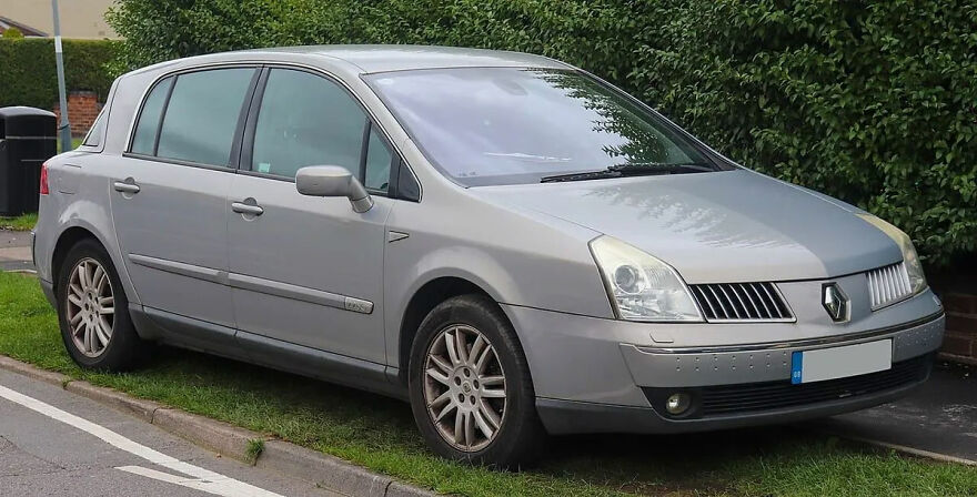 A silver Renault Vel Satis, one of the ugly cars that became legendary, parked on a street.
