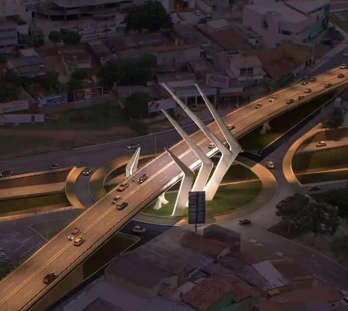 Modern bridge monument with white structural elements over busy road