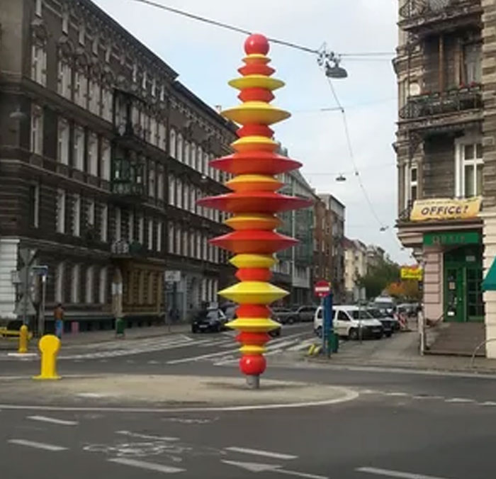 Red and yellow circular disc monument in city street