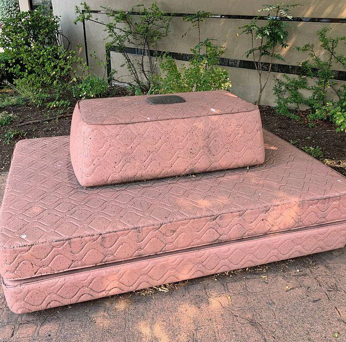 Outdoor installation resembling pink mattresses as ugly monument