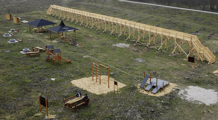 Wooden outdoor monument with stairs and playground structures