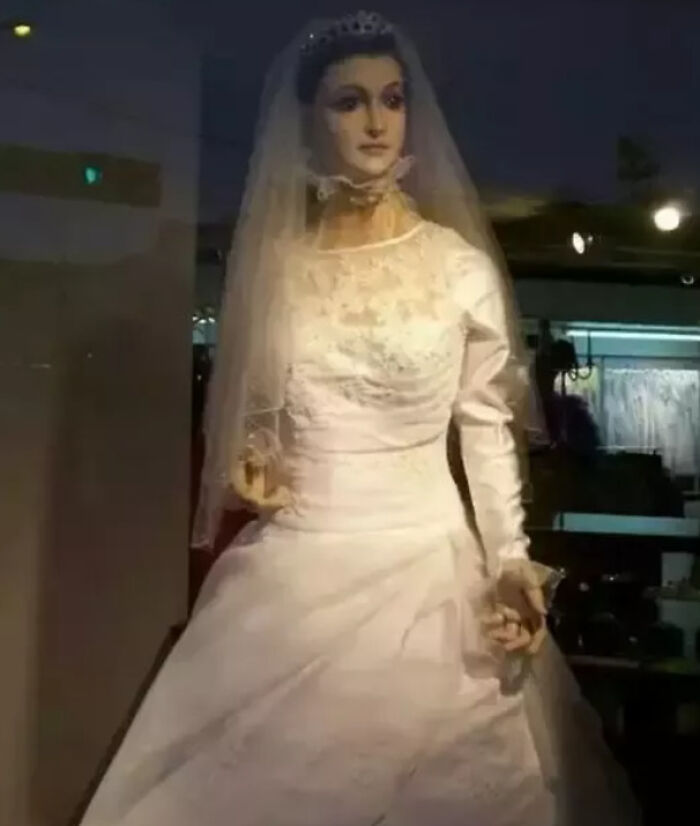 Creepy photo of a lifelike mannequin dressed in a white wedding gown