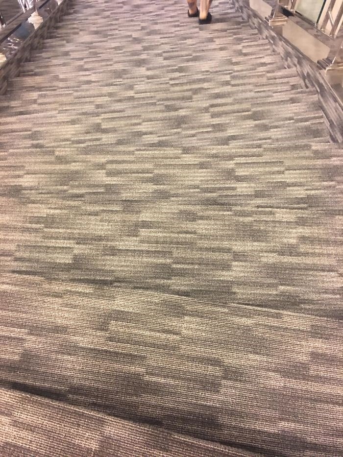 Carpeted stairs with a confusing pattern, making it hard to discern steps, an architecture and design fail.