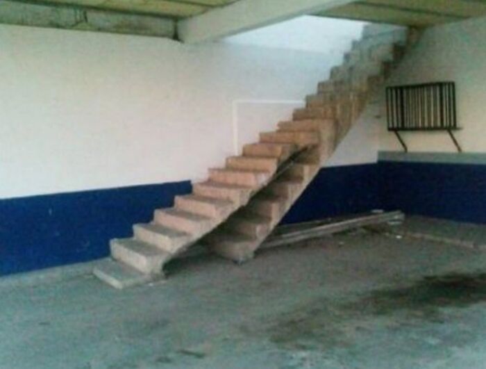 A concrete staircase ending abruptly mid-air against a wall, a clear architecture and design fail.