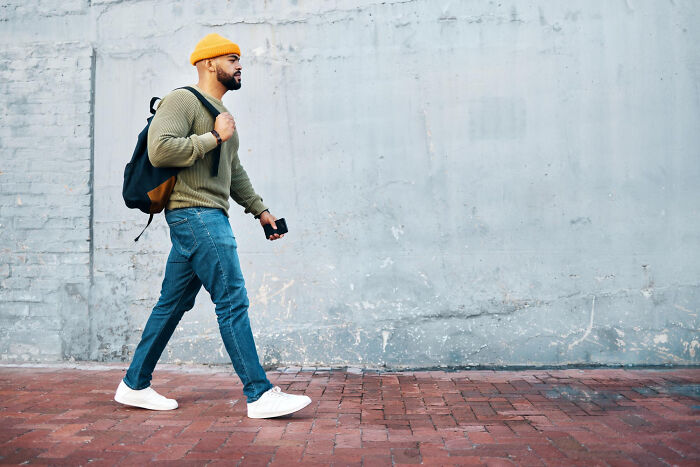 Man walking outside with backpack, illustrating relationships that derailed and breakup stories