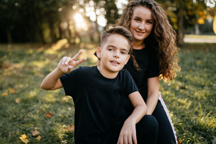 Smiling boy and girl outdoors, representing kids on a beach trip with parents who refuse a bully. Smiling boy and girl outdoors, representing kids on a beach trip with parents who refuse a bully.