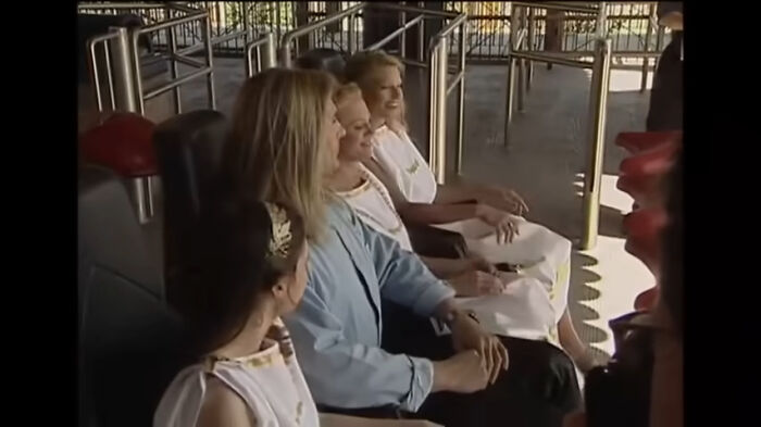 Four women on a rollercoaster, enjoying the ride. Their expressions range from excited to content. This image captures celebrity scandals.