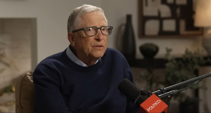 Bill Gates speaking into a microphone. He discusses AI's impact on jobs worldwide and safe careers.
