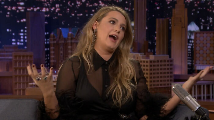 A blonde female celebrity gesticulating on a talk show set, signaling that her fame ran out.