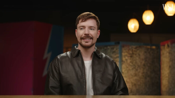 MrBeast, a celebrity whose fame might have run out, smiles wearing a black leather jacket.