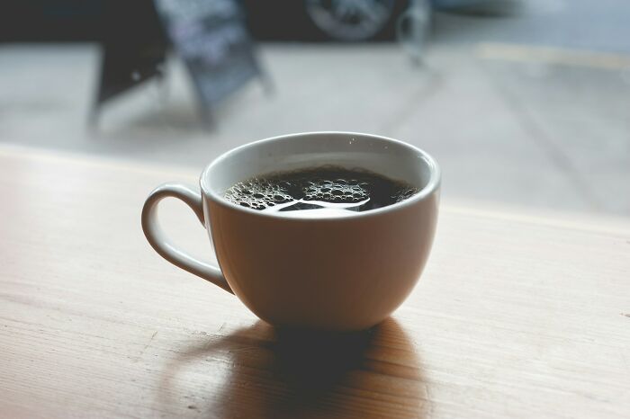 Coffee cup on a table, symbolizing a temporary break from intense stress and burnout.