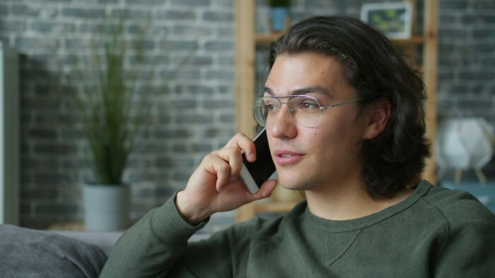 Man talking on phone showing cheating partner reaction