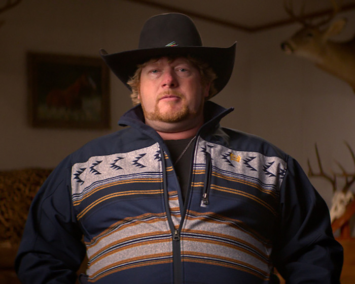 A man in a cowboy hat and patterned jacket, connected to the gruesome details of Taylor Parker.