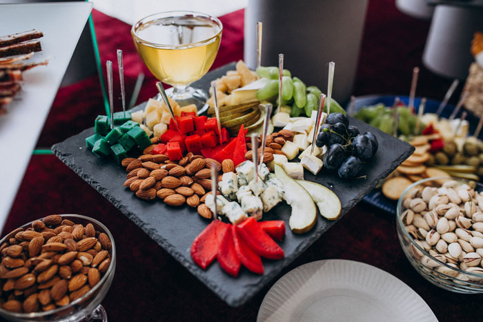 Cheese platter with assorted nuts and fruit at wedding reception Cheese platter with assorted nuts and fruit at wedding reception