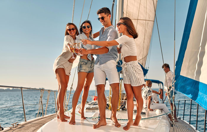 Group of friends celebrating on a yacht during a unique wedding weekend getaway Group of friends celebrating on a yacht during a unique wedding weekend getaway