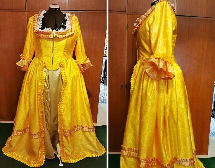 Yellow elaborate wedding dress on a mannequin with ruffled trim and open front design