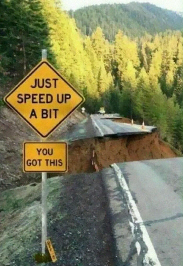 Humorous road sign urging drivers to speed up near road collapse