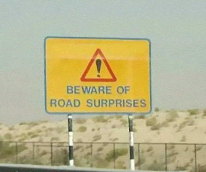 Funny road sign warning of road surprises ahead