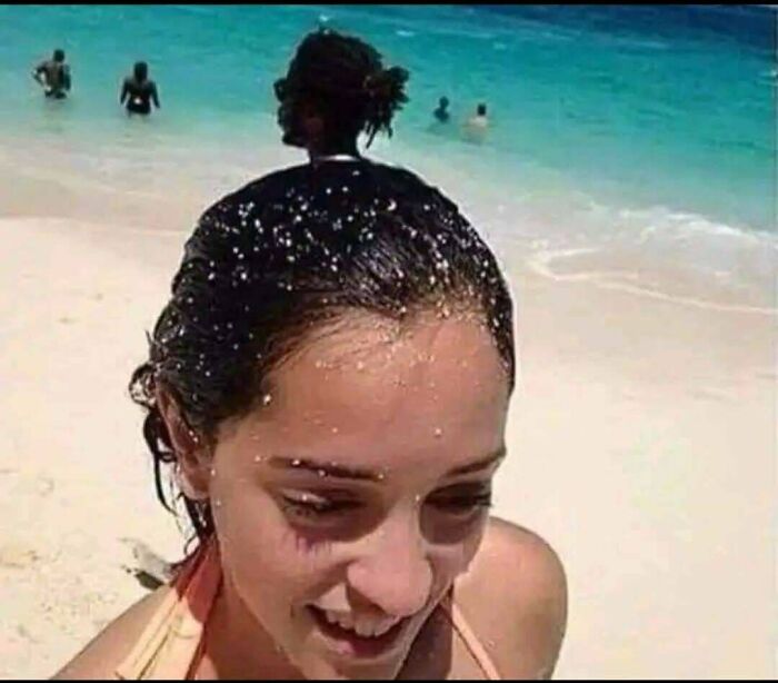 Beach photo with a hidden figure blending into the woman's silhouette, a popular online detectives puzzle