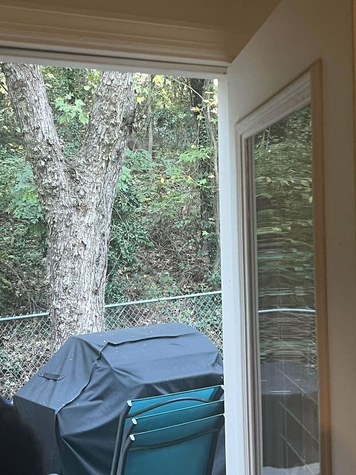 Hidden outdoor grill covered behind window frame and chairs