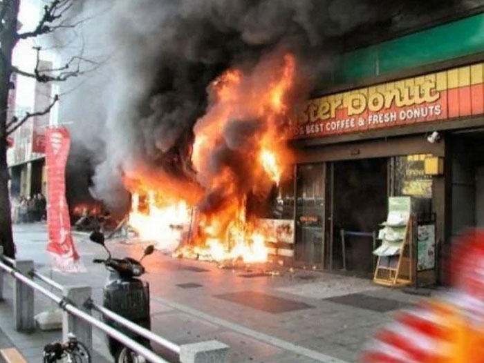 A donut shop engulfed in flames and smoke, a dramatic When You See It Picture.