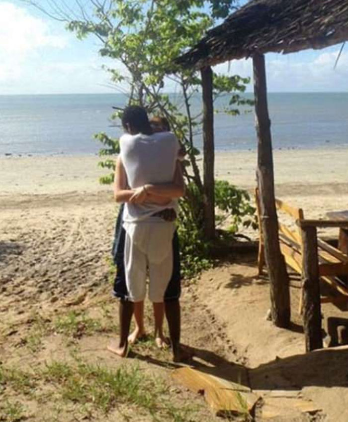A couple embracing on a beach, creating a confusing visual for this 'When You See It' picture.