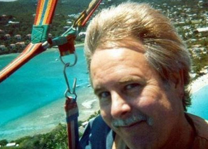 A man parasailing with a vibrant blue ocean background, featuring a hidden detail for a When You See It moment.