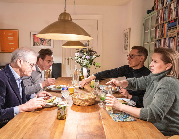 World leaders enjoying meal together at dining table