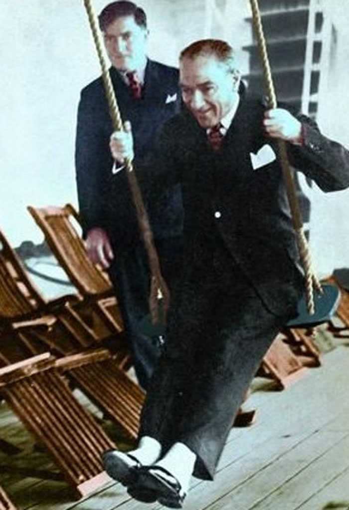 Historic picture of world leader happily swinging indoors