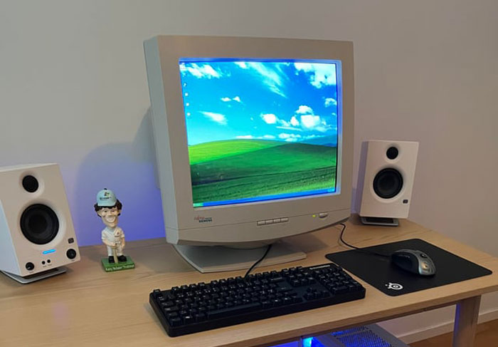 Old computer setup showing Windows XP wallpaper on CRT monitor Old computer setup showing Windows XP wallpaper on CRT monitor