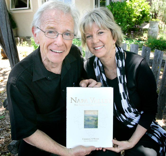 Couple holding Napa Valley book featuring most viewed photo ever scene Couple holding Napa Valley book featuring most viewed photo ever scene