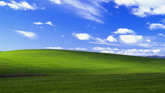 Famous green hill landscape under blue sky, most viewed photo ever background Famous green hill landscape under blue sky, most viewed photo ever background