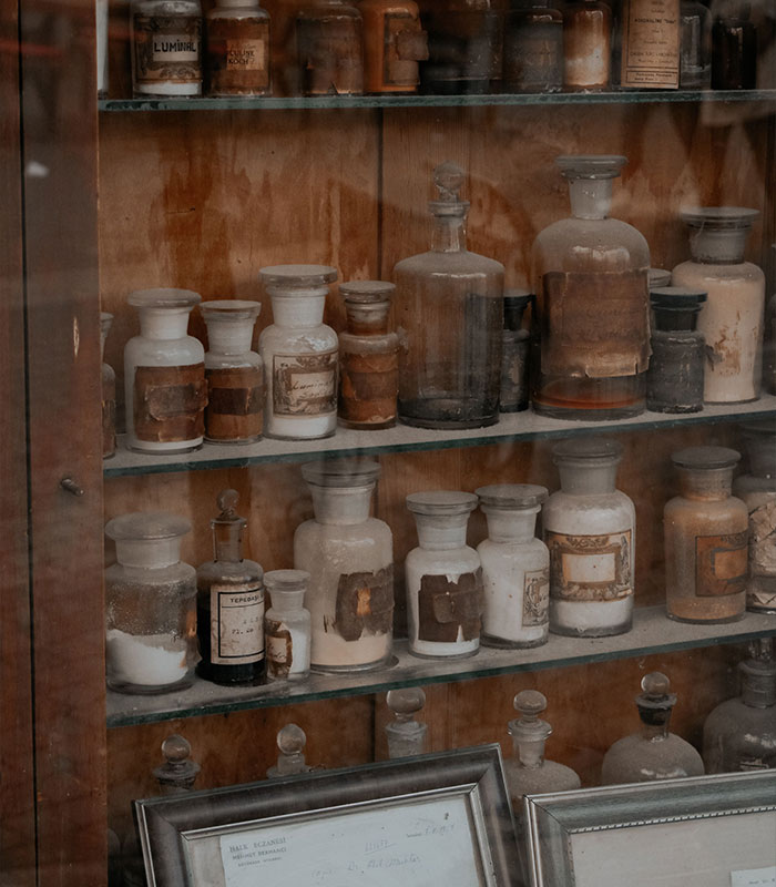 Shelf with old dusty vintage apothecary jars and glass bottles Shelf with old dusty vintage apothecary jars and glass bottles