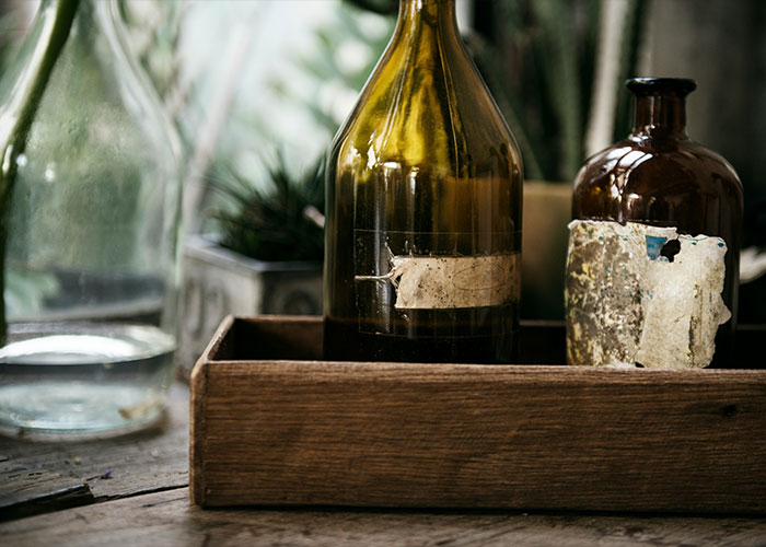 Antique glass bottles in wooden crate evoking mysterious remedies for marriages Antique glass bottles in wooden crate evoking mysterious remedies for marriages