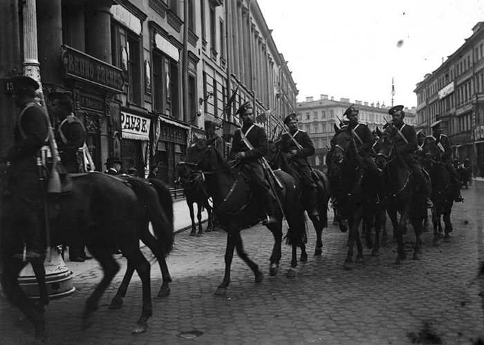 Black and white image of mounted soldiers on city street hinting at historic intrigue Black and white image of mounted soldiers on city street hinting at historic intrigue