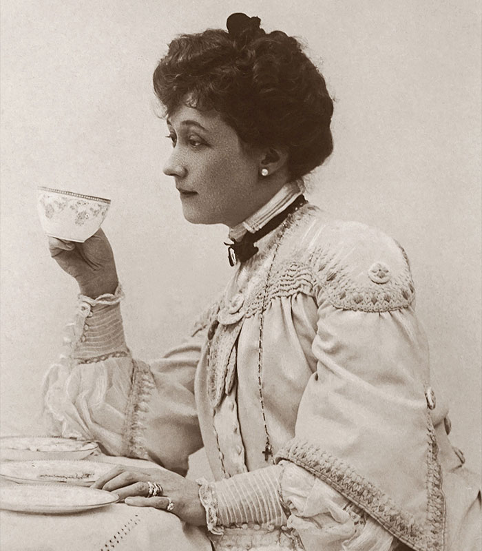 Vintage portrait of a woman drinking tea hinting at secretive marriage advice Vintage portrait of a woman drinking tea hinting at secretive marriage advice