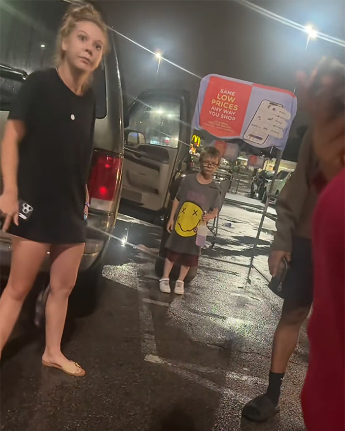 Woman and children near car involved in hot car incident at night Woman and children near car involved in hot car incident at night