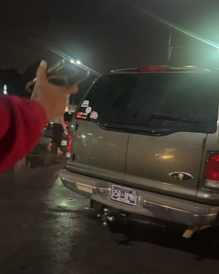 Night scene showing hand pointing at vehicle involved in kids left in hot car Night scene showing hand pointing at vehicle involved in kids left in hot car