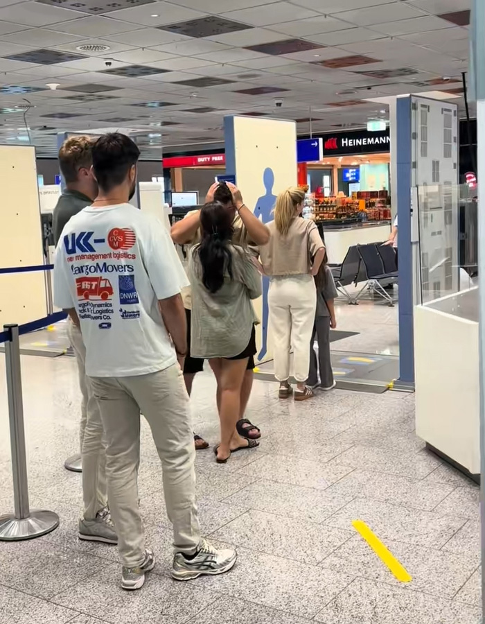 People waiting in line at airport security checkpoint