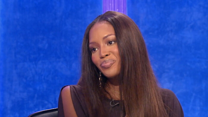 Woman with long hair and black top reflecting on celebrity encounters