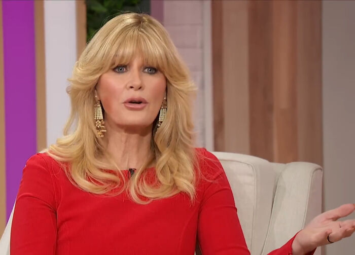 Blonde woman in red dress discussing disappointing celebrity encounters