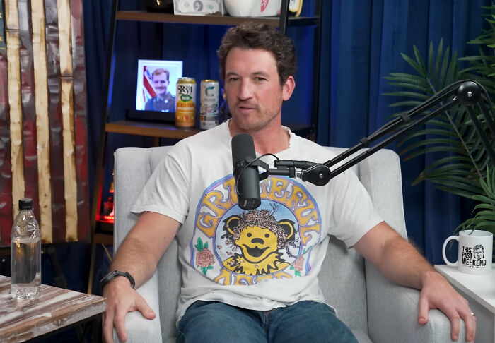 Casual man speaking into microphone on podcast set