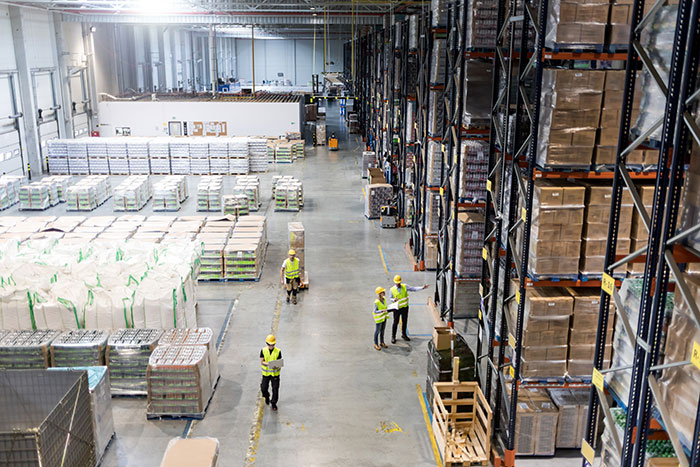Warehouse workers managing inventory representing fired employees scenarios